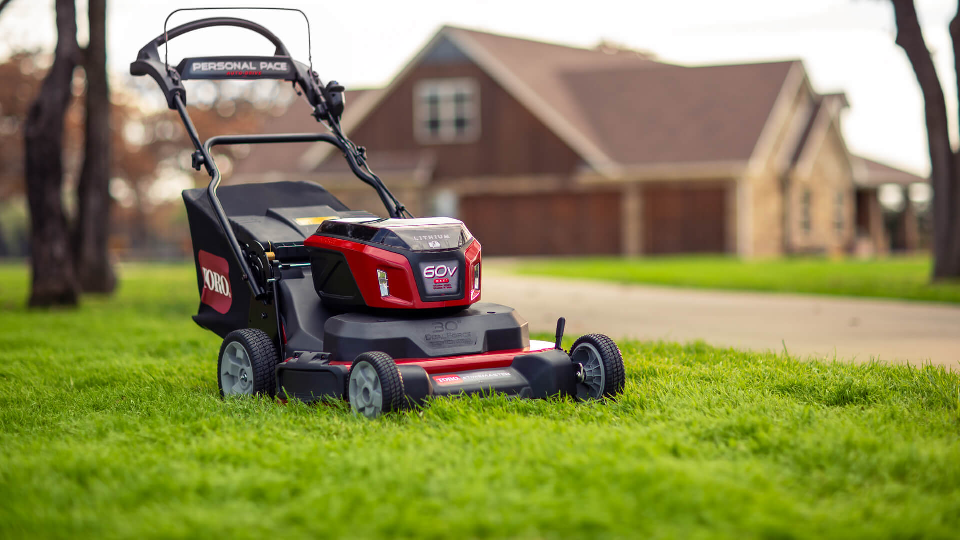 Toro 30-inch 60V eTimeMaster Personal Pace mower on a freshly cut lawn